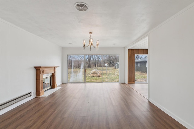 unfurnished living room with a wealth of natural light, wood finished floors, a baseboard radiator, and a notable chandelier