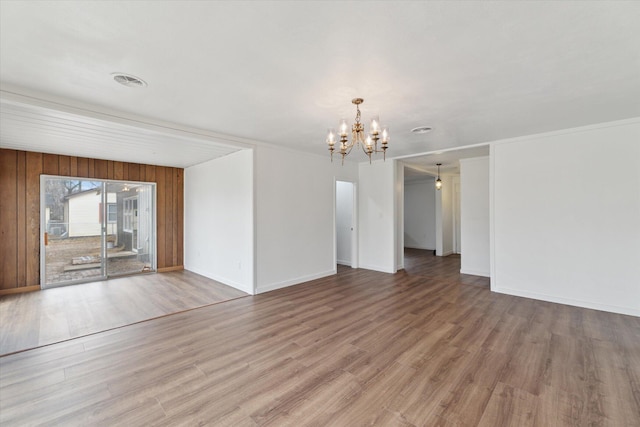 interior space with an inviting chandelier, baseboards, and wood finished floors
