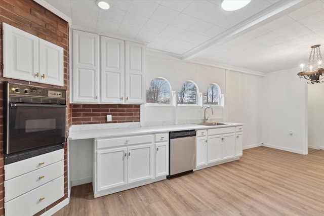 kitchen with dishwasher, a sink, black oven, white cabinets, and light wood-type flooring