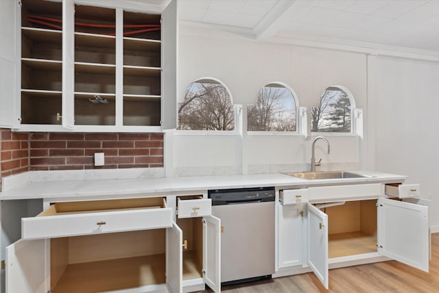 kitchen with dishwasher, light wood finished floors, a sink, light countertops, and white cabinets