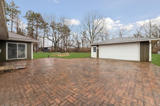 view of patio / terrace with an outbuilding and a detached garage