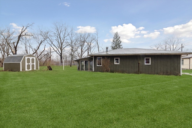 view of yard featuring an outbuilding, a sunroom, and a storage shed