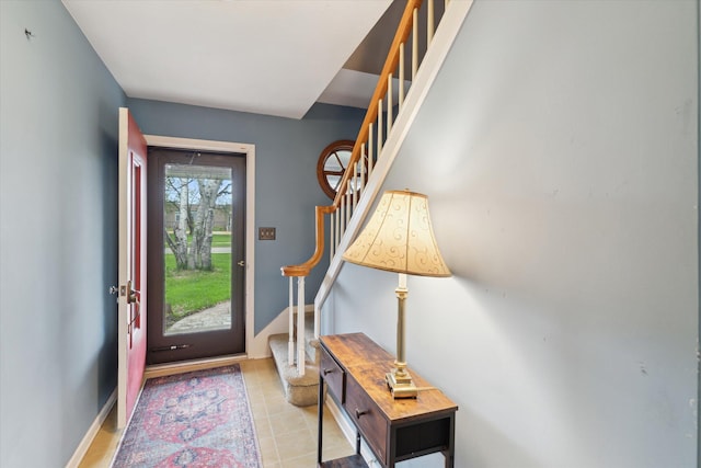 entryway with light tile patterned floors and stairway