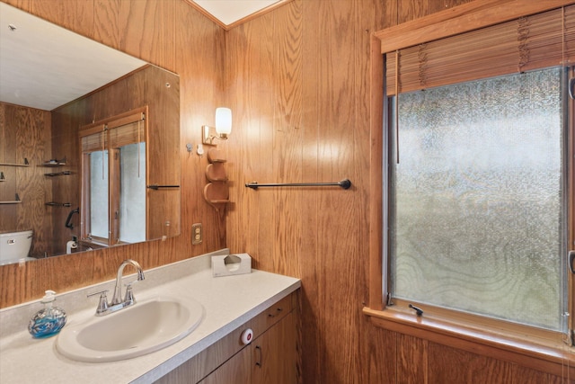 bathroom with wooden walls and vanity
