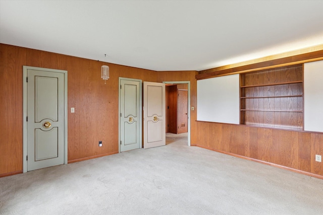 spare room with wood walls and carpet