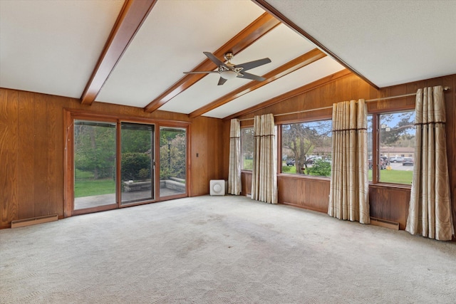 unfurnished room with ceiling fan, carpet flooring, wood walls, and a baseboard heating unit