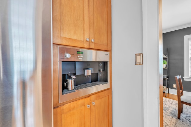 kitchen featuring crown molding, decorative backsplash, and wood finished floors