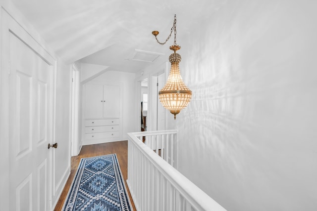 hall with attic access and dark wood-type flooring
