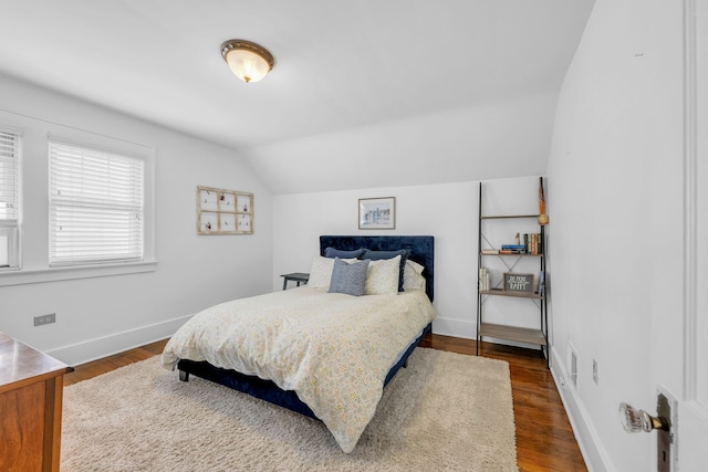 bedroom featuring vaulted ceiling, baseboards, and dark wood-type flooring