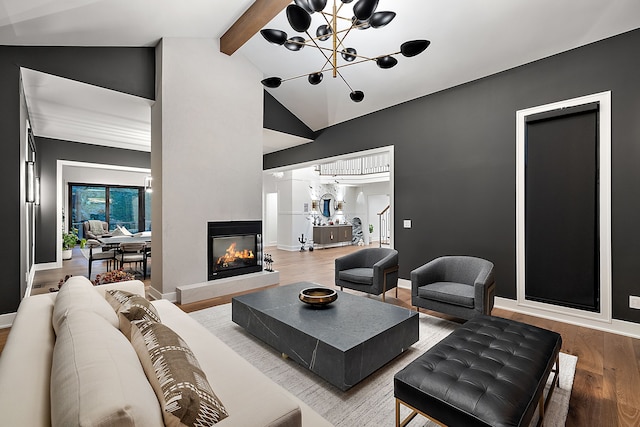 living room with wood finished floors, high vaulted ceiling, a multi sided fireplace, beamed ceiling, and a chandelier