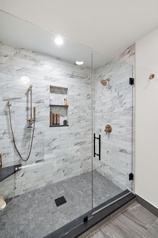 bathroom featuring baseboards, a shower stall, and recessed lighting