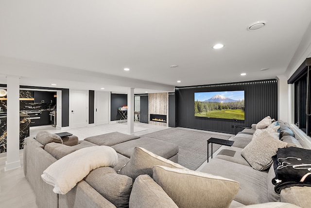 home theater room with a large fireplace and recessed lighting