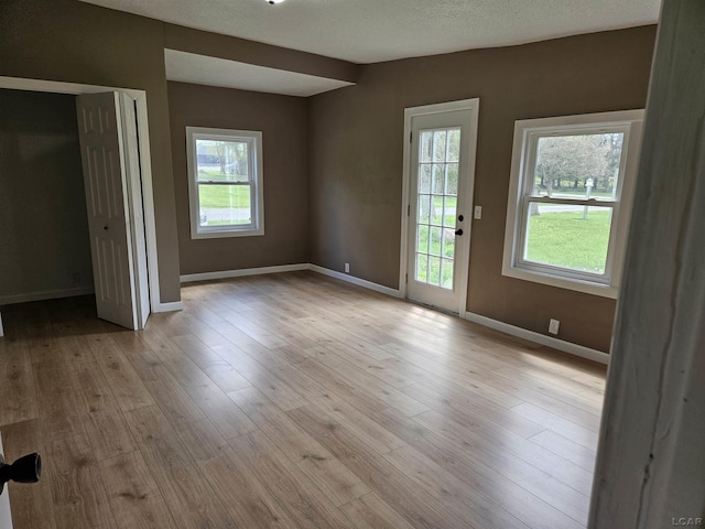 4084 Seneca St, Weston, MI 49289 - unfurnished bedroom featuring baseboards, light wood-type flooring, and access to exterior