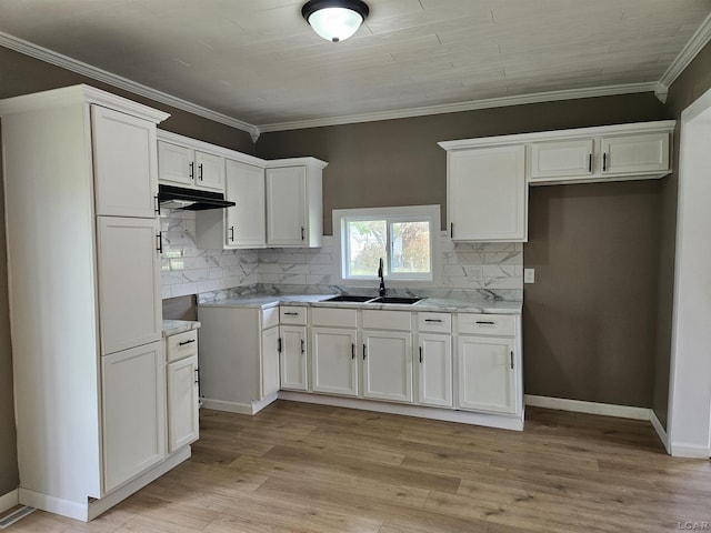 4084 Seneca St, Weston, MI 49289 - kitchen with a sink, white cabinetry, under cabinet range hood, tasteful backsplash, and ornamental molding