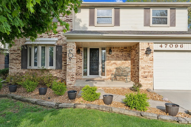 traditional-style home featuring covered porch, brick siding, and an attached garage