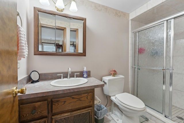 bathroom featuring a shower stall, vanity, and toilet