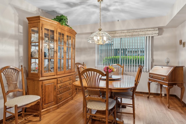 dining room featuring a notable chandelier and light wood finished floors