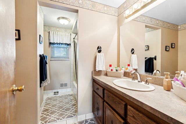 full bath with  shower combination, vanity, and visible vents
