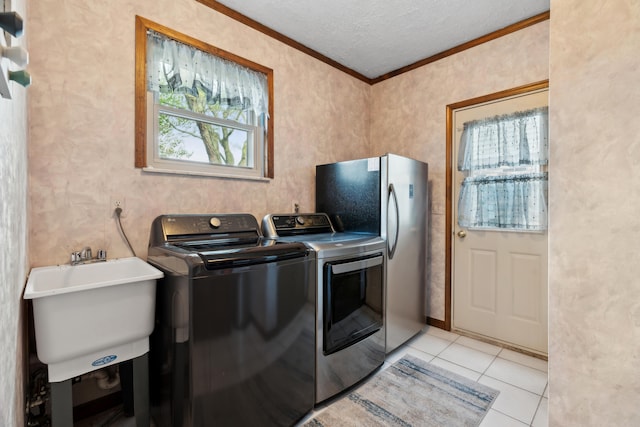 laundry room with independent washer and dryer, laundry area, a textured ceiling, crown molding, and light tile patterned floors