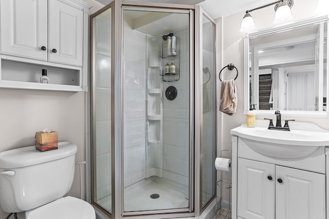 full bath featuring vanity, toilet, and a stall shower