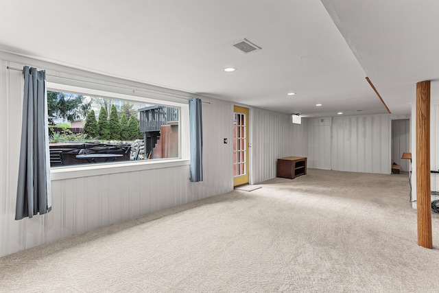 below grade area featuring carpet flooring, visible vents, and recessed lighting