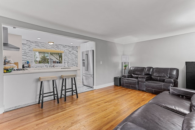 living room featuring baseboards and light wood-style floors