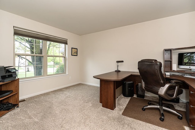 carpeted office space featuring baseboards