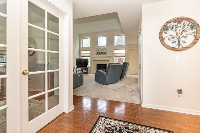 hall with hardwood / wood-style floors, french doors, and baseboards