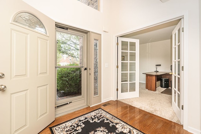 foyer featuring french doors and wood finished floors