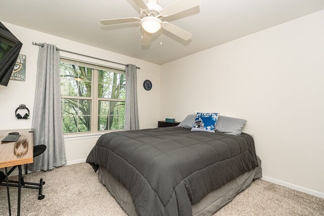 bedroom featuring carpet, baseboards, and a ceiling fan