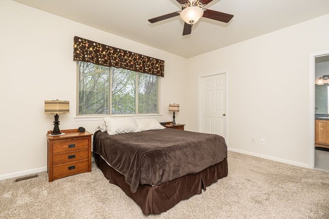 bedroom featuring carpet, baseboards, and ensuite bath