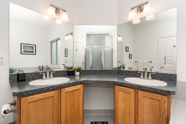 full bath with a shower stall and double vanity