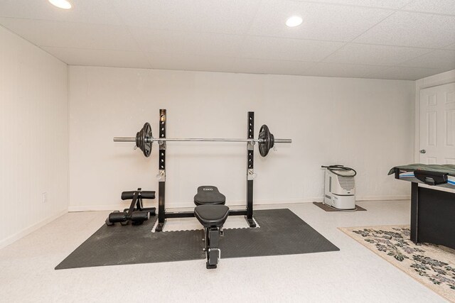 workout room with baseboards, a drop ceiling, and recessed lighting