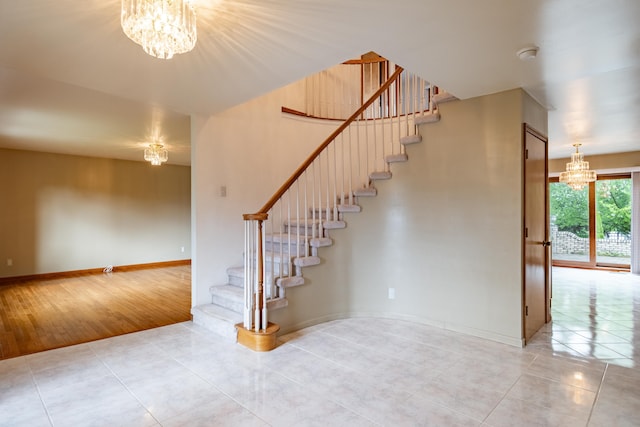 stairs featuring a chandelier, tile patterned flooring, and baseboards