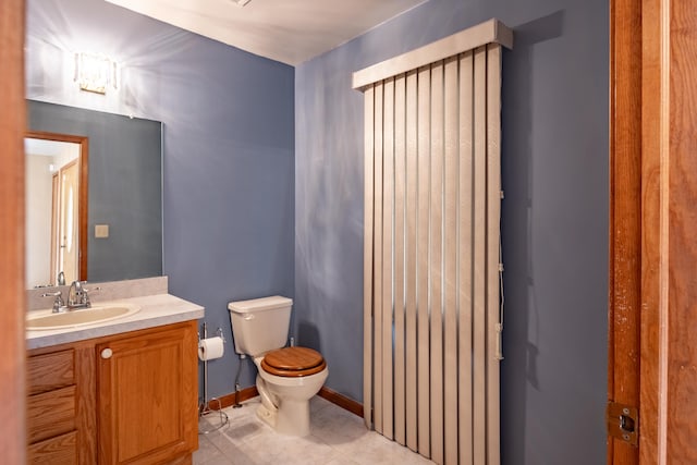bathroom featuring toilet, tile patterned floors, and vanity
