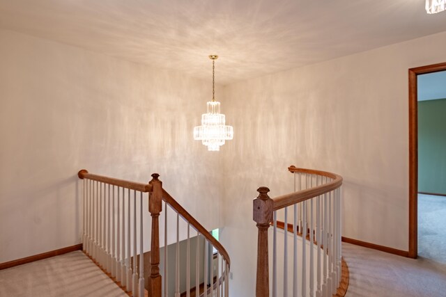 staircase featuring carpet, a chandelier, and baseboards