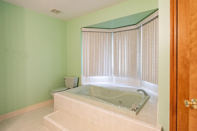 full bathroom with toilet, tile patterned flooring, a tub with jets, and baseboards