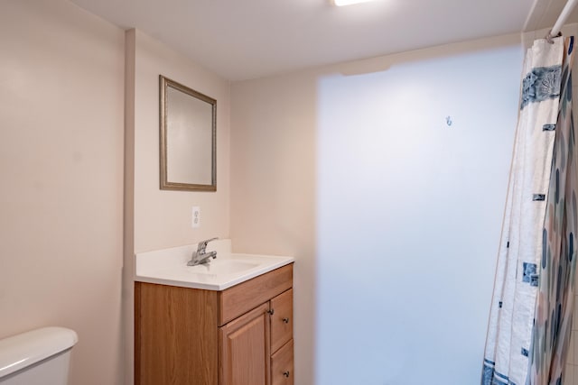 bathroom featuring toilet and vanity