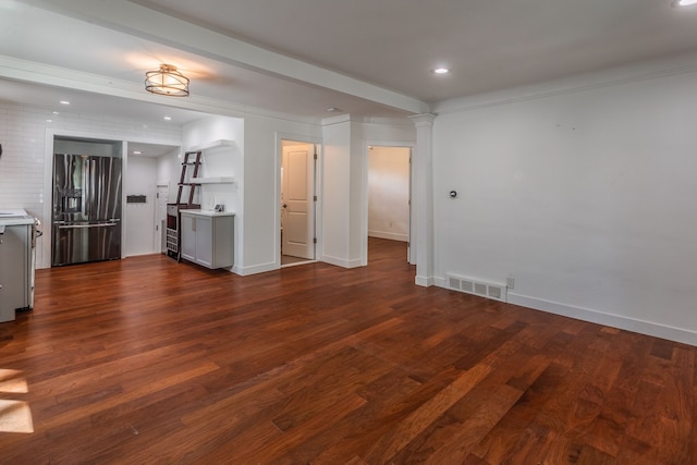 unfurnished living room with dark wood-style floors, recessed lighting, baseboards, and decorative columns
