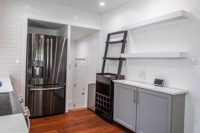 kitchen with appliances with stainless steel finishes, gray cabinets, dark wood-style flooring, open shelves, and recessed lighting