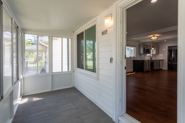 unfurnished sunroom featuring a sink