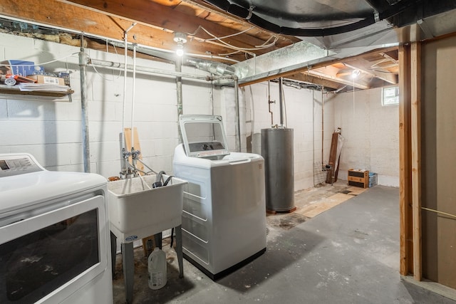 below grade area with water heater, washing machine and clothes dryer, and a sink