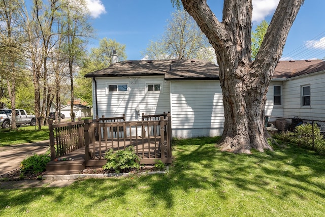 back of property featuring a yard and a wooden deck