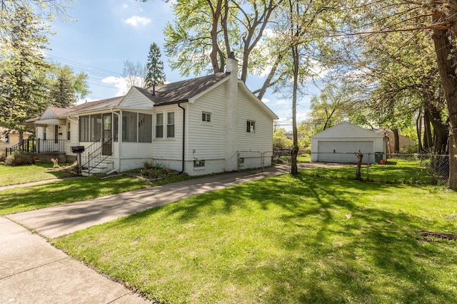 view of home's exterior featuring a garage, a chimney, and a sunroom