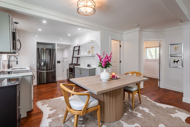 dining space with dark wood-type flooring, recessed lighting, ornamental molding, and baseboards