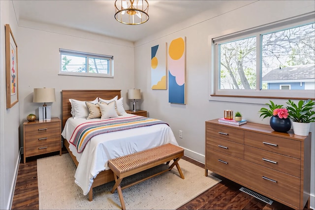 bedroom featuring baseboards and dark wood finished floors