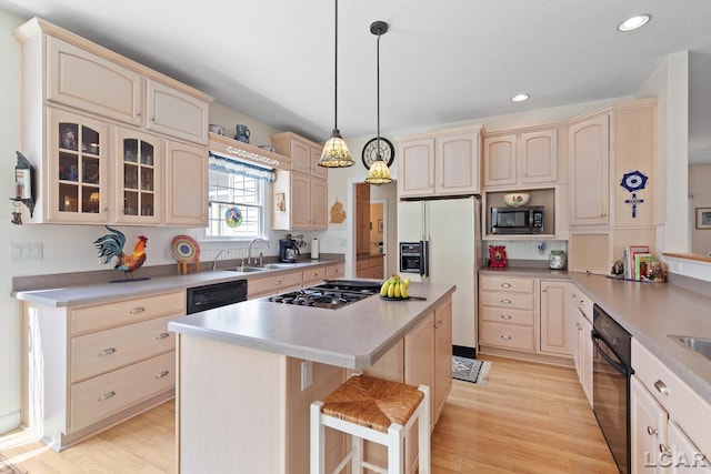 5225 Bent Oak Hwy, Adrian, MI 49221 - kitchen with a sink, light wood-style flooring, light countertops, a center island, and appliances with stainless steel finishes