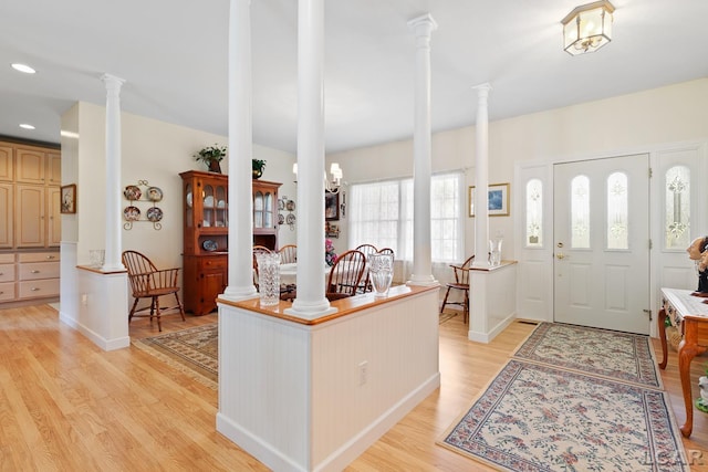 5225 Bent Oak Hwy, Adrian, MI 49221 - kitchen featuring recessed lighting, baseboards, light wood-style floors, light countertops, and ornate columns