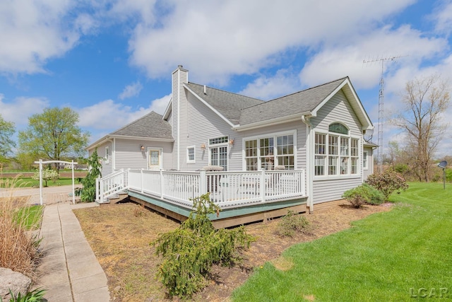 5225 Bent Oak Hwy, Adrian, MI 49221 - rear view of property featuring a yard, a wooden deck, a shingled roof, and a chimney