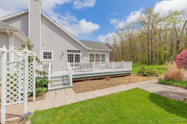 5225 Bent Oak Hwy, Adrian, MI 49221 - back of house featuring roof with shingles, a deck, a chimney, and a lawn